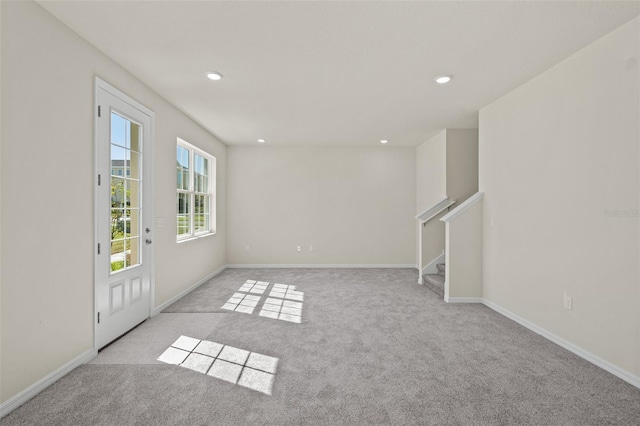 spare room with light colored carpet