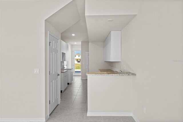 kitchen featuring white cabinets and light tile patterned floors