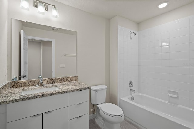 full bathroom featuring toilet, vanity, and tiled shower / bath