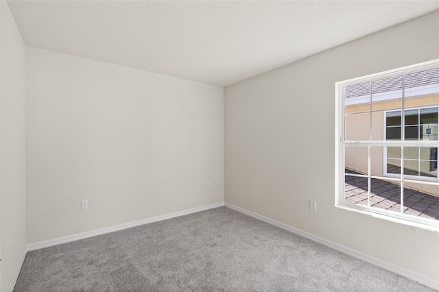 unfurnished room featuring light carpet