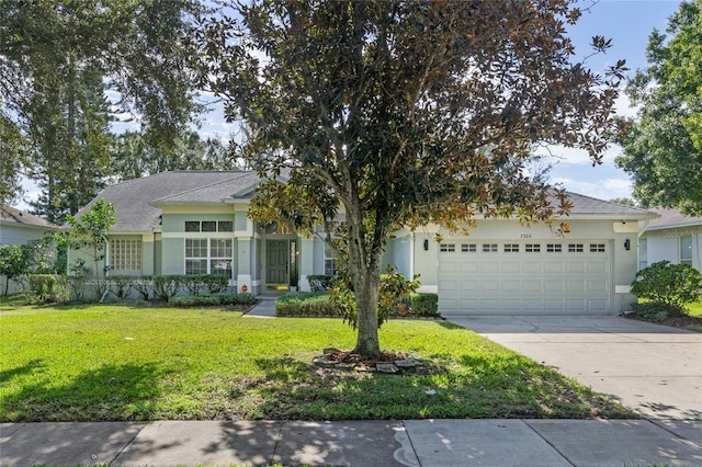 view of front of property featuring a front yard and a garage