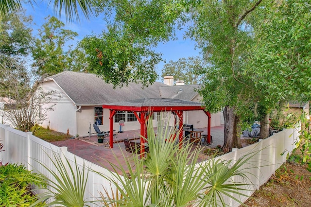 rear view of property featuring a patio area