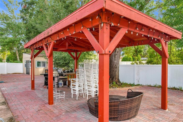 view of patio / terrace featuring a gazebo, grilling area, and exterior bar