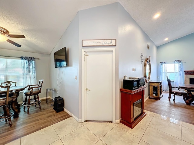 kitchen featuring a textured ceiling, light hardwood / wood-style flooring, and a wealth of natural light