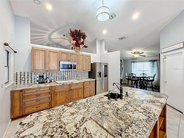 kitchen featuring ceiling fan, sink, stainless steel appliances, high vaulted ceiling, and backsplash