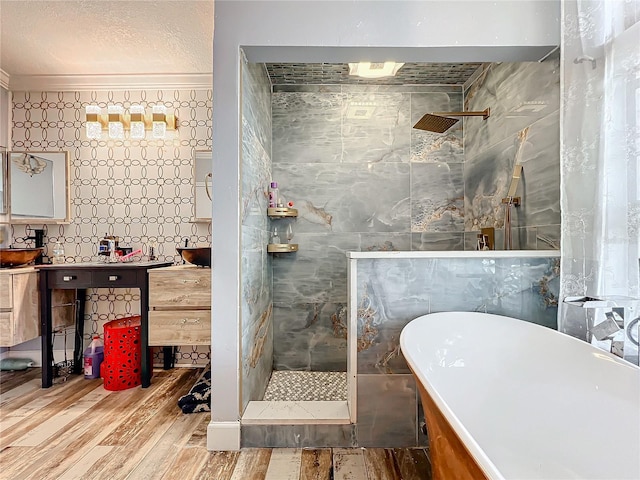 bathroom with ornamental molding, hardwood / wood-style flooring, tile walls, and independent shower and bath