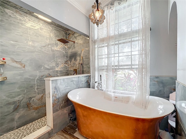 bathroom featuring plenty of natural light, shower with separate bathtub, and tile walls