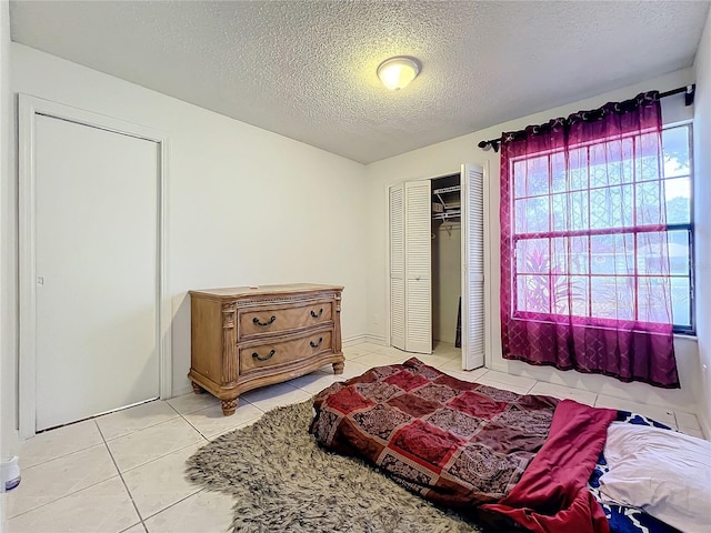 tiled bedroom with a textured ceiling