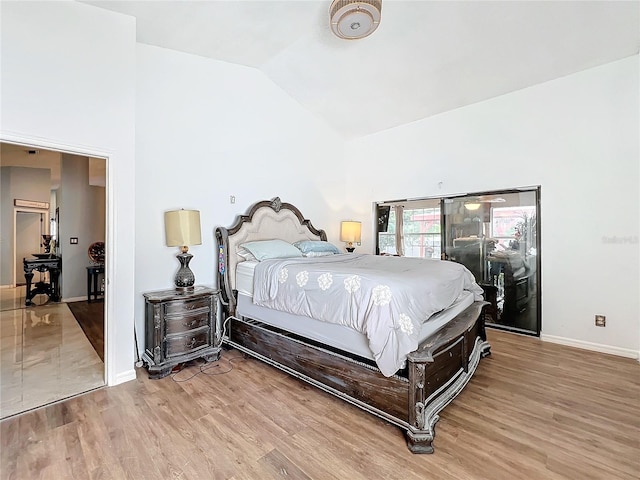 bedroom featuring hardwood / wood-style flooring and high vaulted ceiling