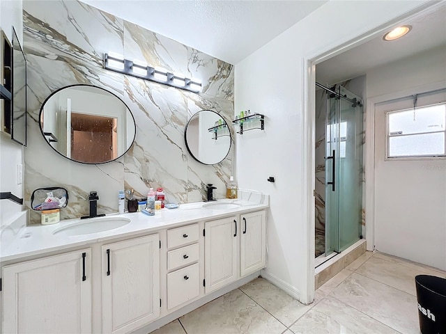 bathroom with vanity, an enclosed shower, and tile walls