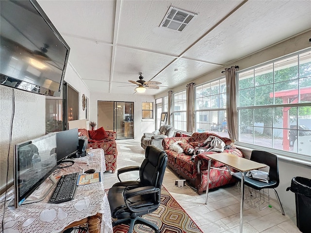 sunroom featuring ceiling fan