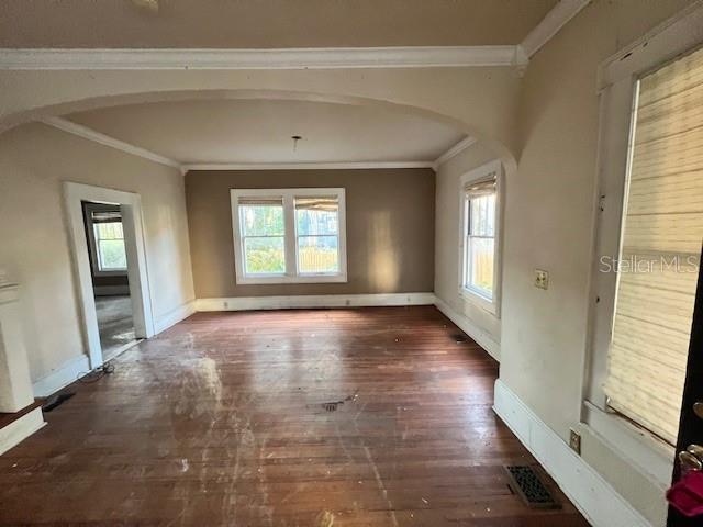 interior space with dark hardwood / wood-style flooring and crown molding