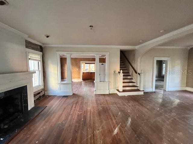 unfurnished living room featuring crown molding and dark hardwood / wood-style floors