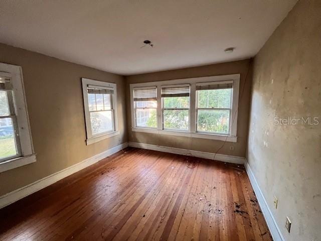 unfurnished room featuring hardwood / wood-style flooring