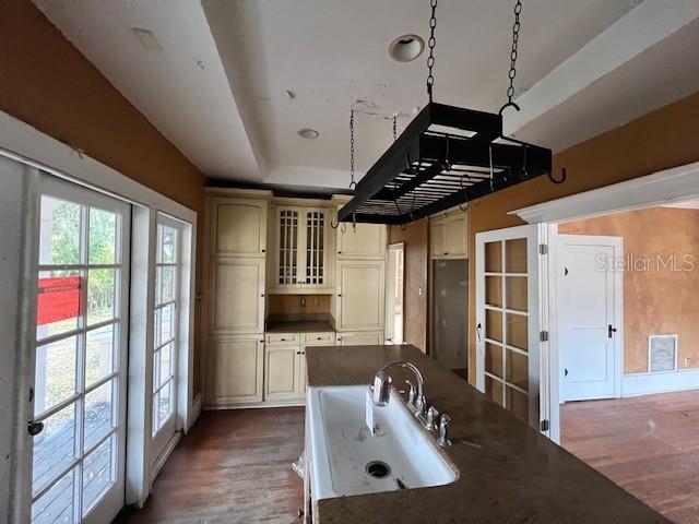 kitchen featuring cream cabinetry, hardwood / wood-style floors, a healthy amount of sunlight, and sink