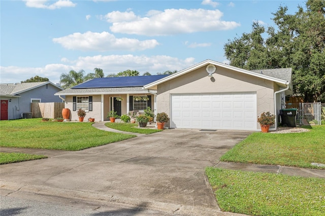 ranch-style home with solar panels, a front yard, covered porch, central AC unit, and a garage