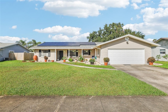 ranch-style home with a porch, solar panels, a garage, and a front lawn