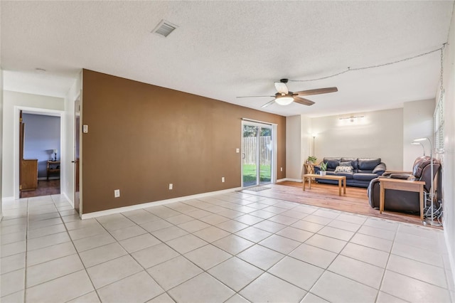 tiled living room featuring ceiling fan and a textured ceiling