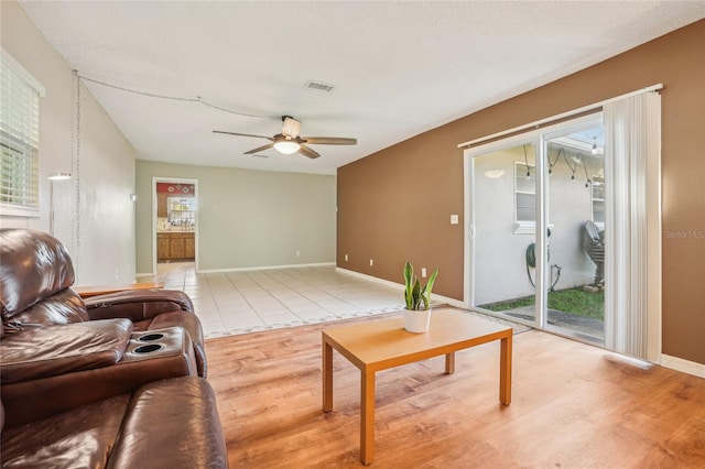 living room with ceiling fan and light wood-type flooring