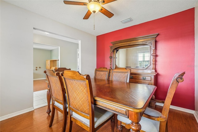 dining space with a textured ceiling, hardwood / wood-style flooring, and ceiling fan