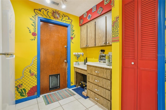 bathroom featuring tile patterned floors, vanity, and a textured ceiling