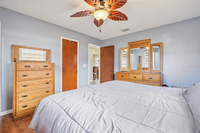 bedroom with wood-type flooring and ceiling fan