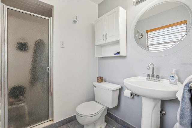 bathroom featuring tile patterned floors, toilet, and walk in shower