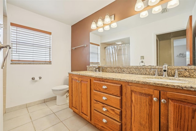 bathroom featuring toilet, vanity, and tile patterned floors