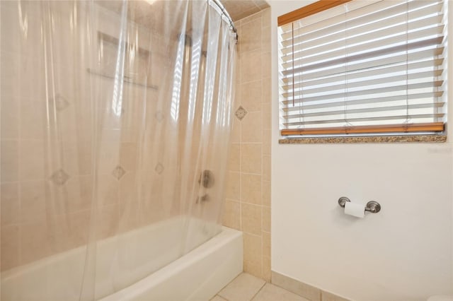 bathroom featuring tile patterned flooring and shower / tub combo with curtain