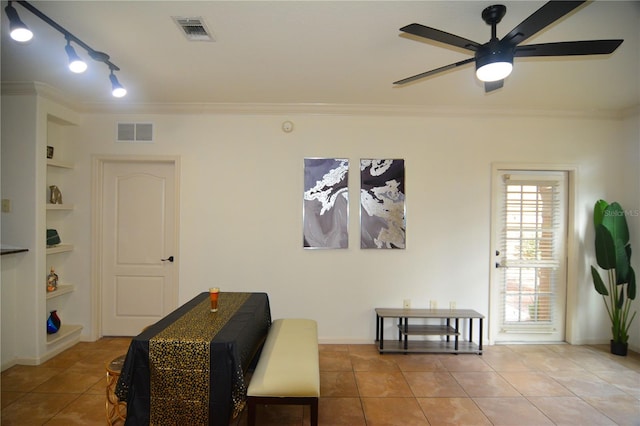 sitting room featuring built in shelves, tile patterned floors, ceiling fan, and ornamental molding