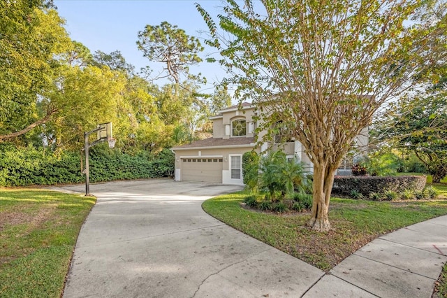 view of front facade with a front yard and a garage