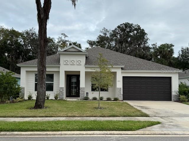 view of front facade with a front yard and a garage