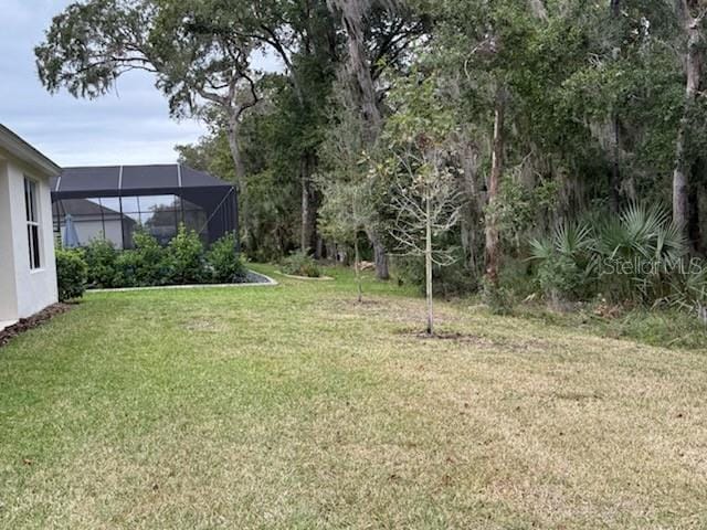 view of yard featuring glass enclosure