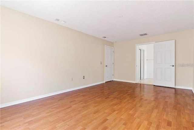 spare room featuring hardwood / wood-style floors