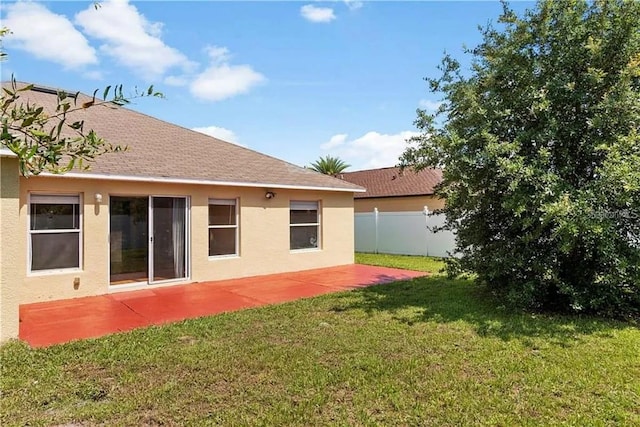 rear view of property with a patio area and a lawn