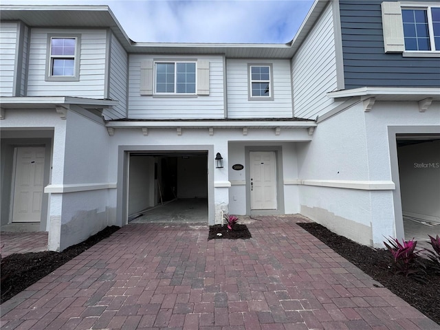 view of exterior entry with a garage