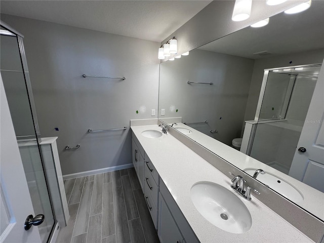 full bathroom with toilet, a sink, and wood finish floors