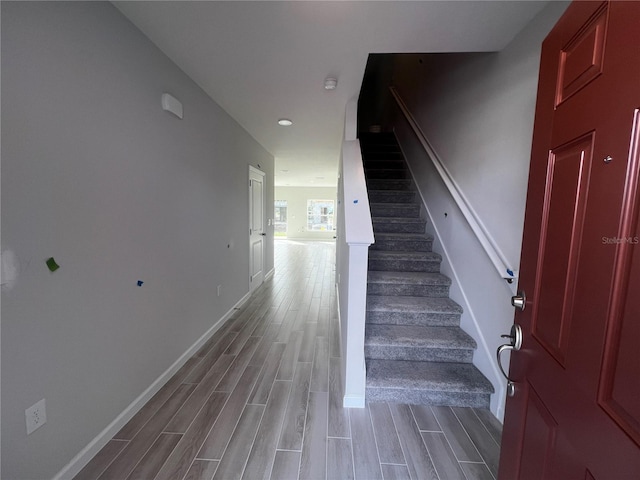 stairs featuring baseboards and wood tiled floor