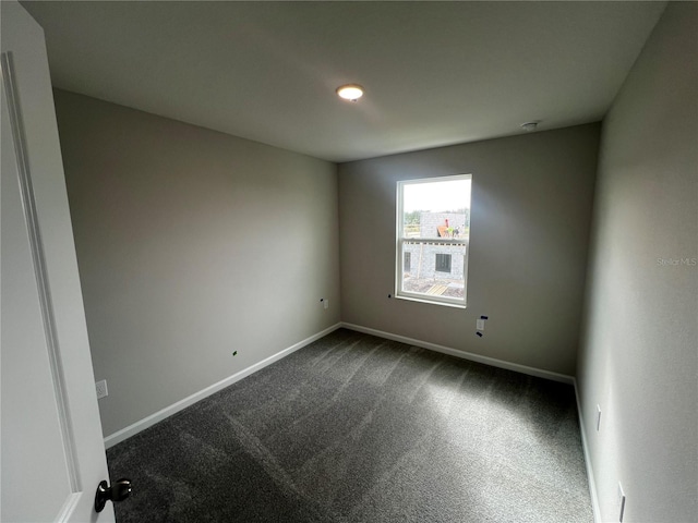 carpeted empty room with baseboards