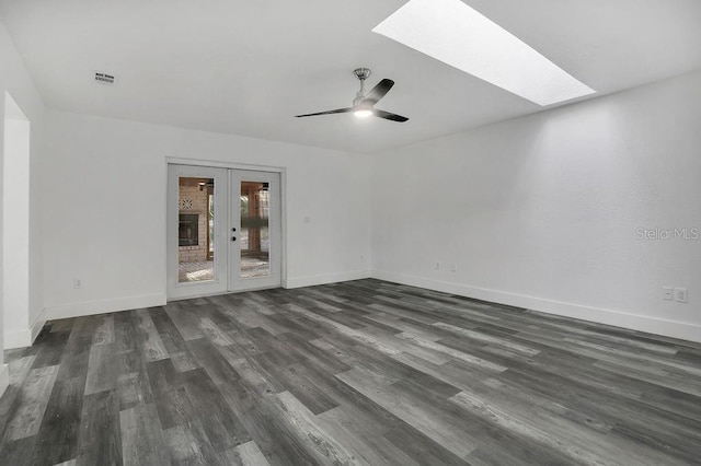 unfurnished room with french doors, a skylight, ceiling fan, and dark wood-type flooring