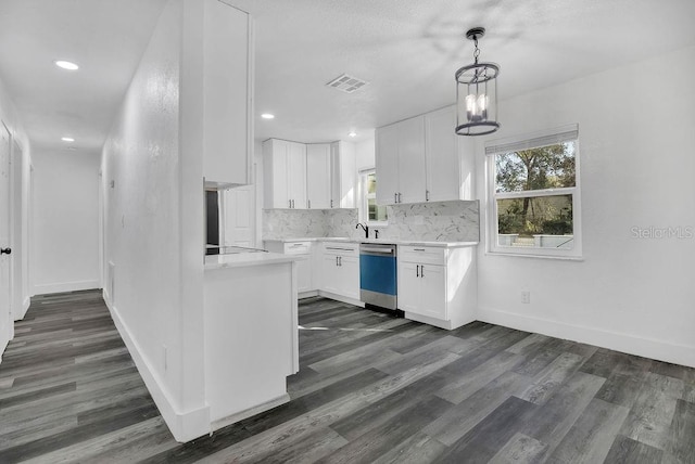 kitchen featuring stainless steel dishwasher, dark hardwood / wood-style floors, a notable chandelier, pendant lighting, and white cabinets