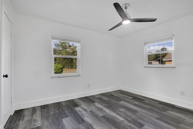 spare room with ceiling fan, a healthy amount of sunlight, and dark wood-type flooring