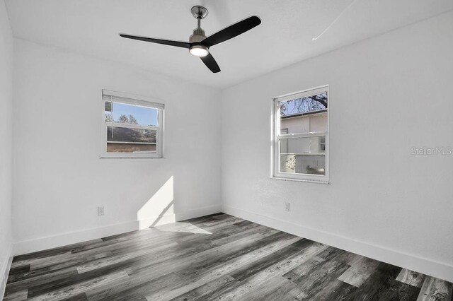 empty room featuring dark hardwood / wood-style flooring and ceiling fan