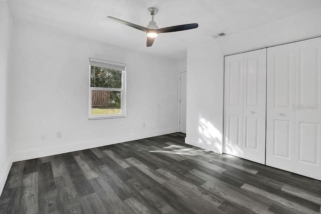 unfurnished bedroom with ceiling fan and dark hardwood / wood-style flooring