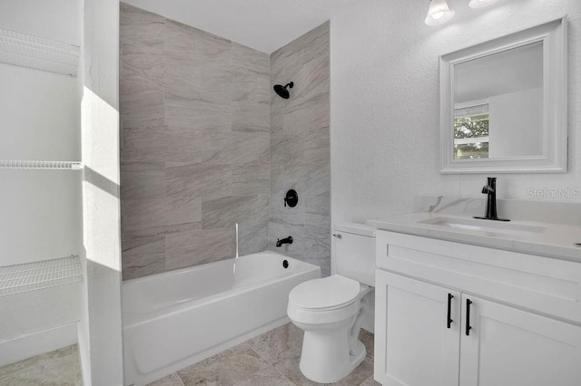 full bathroom with tile patterned floors, vanity, toilet, and tiled shower / bath