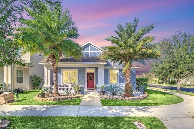 view of front of house featuring a yard and a porch