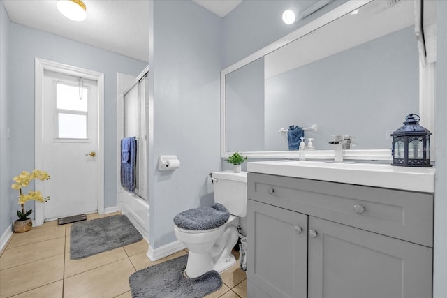 full bathroom featuring toilet, tile patterned flooring, vanity, and combined bath / shower with glass door