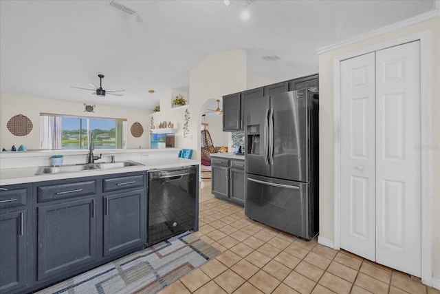 kitchen featuring stainless steel fridge, light tile patterned flooring, lofted ceiling, and black dishwasher