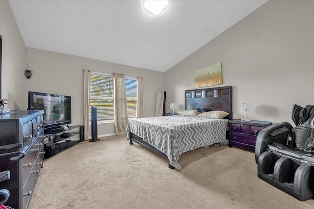 carpeted bedroom with high vaulted ceiling