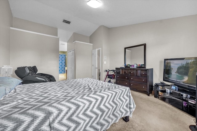 carpeted bedroom with lofted ceiling and a textured ceiling